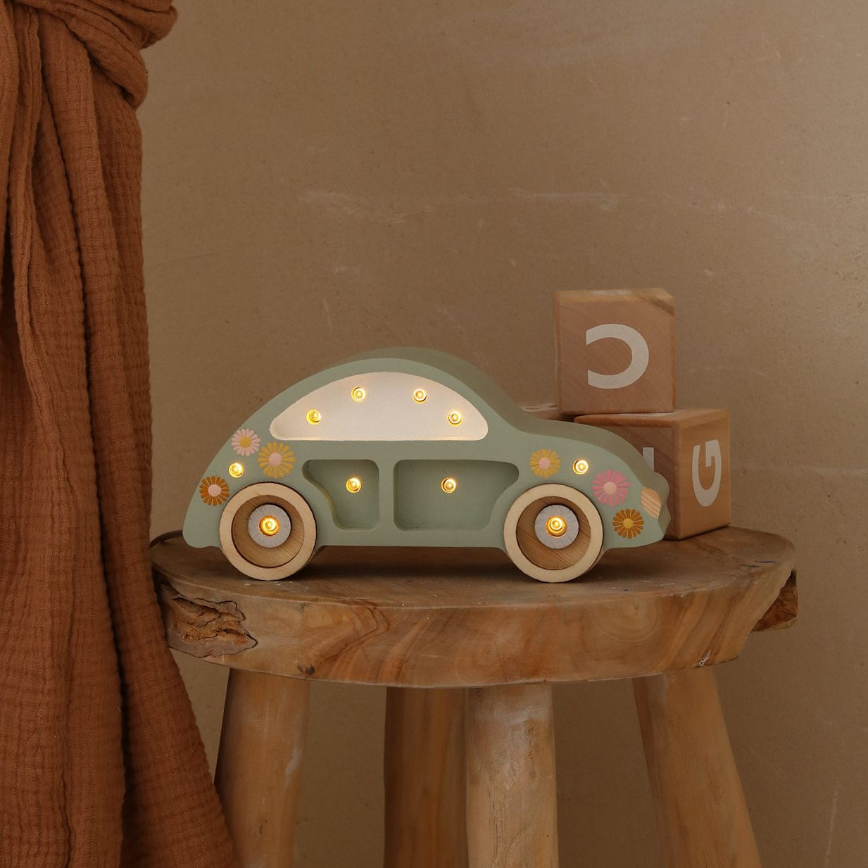 Little Lights Mino Beetle Car Night Light on a stool in a kid's room