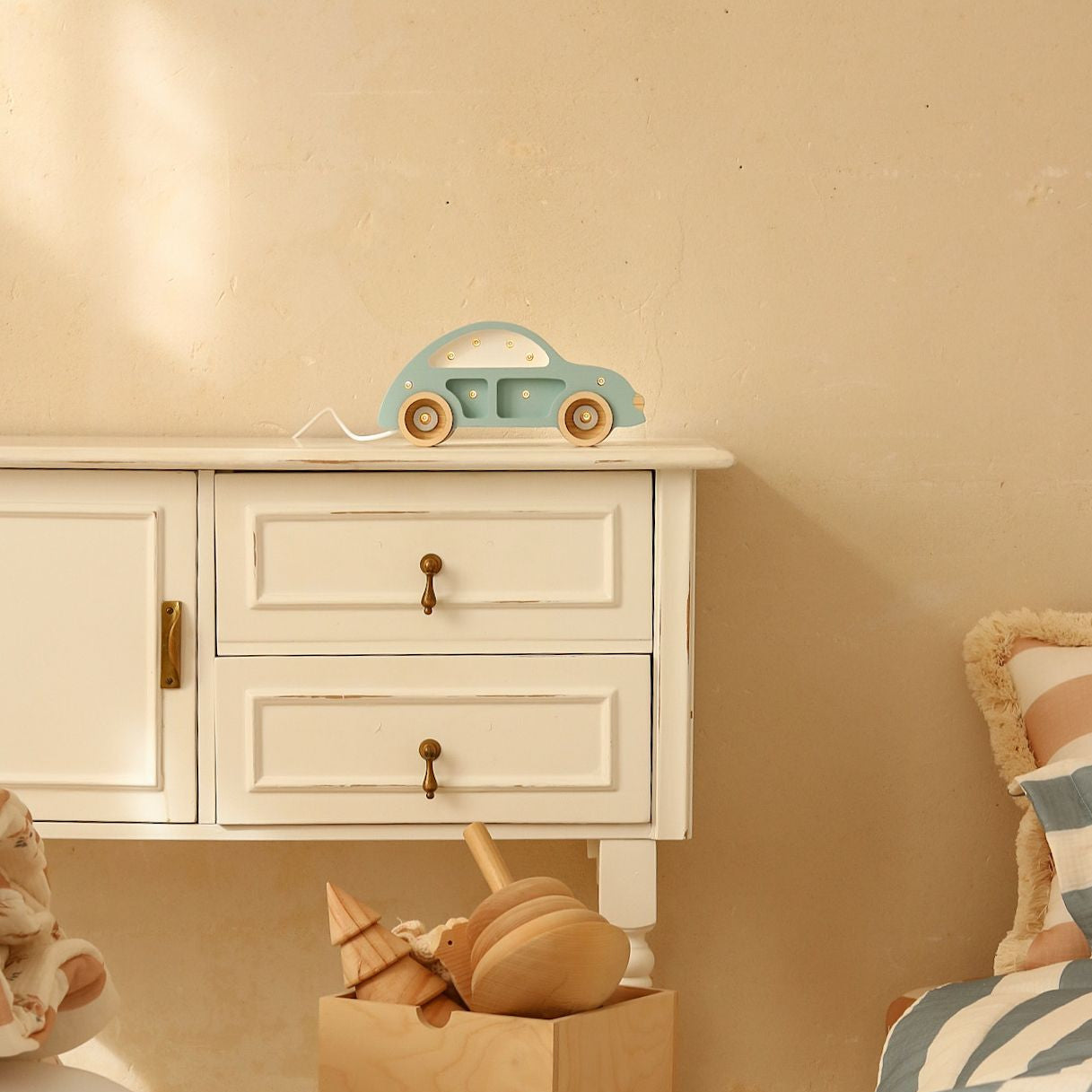 Little Lights Mini Beetle blue night light on a dresser in a kid's room