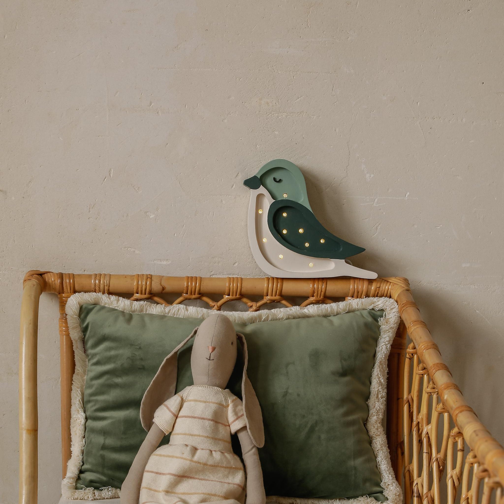 Little Lights green Mini Bird night light glowing in a kids room