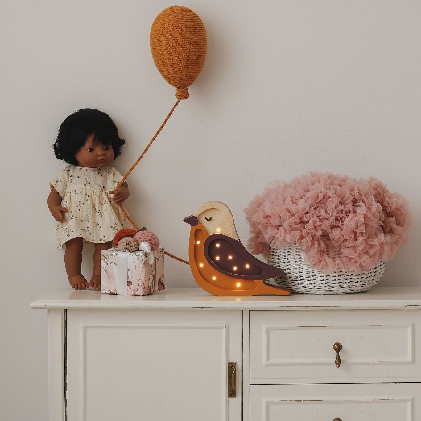 Little Lights brown Mini Bird lamp on a dresser in a girl's room