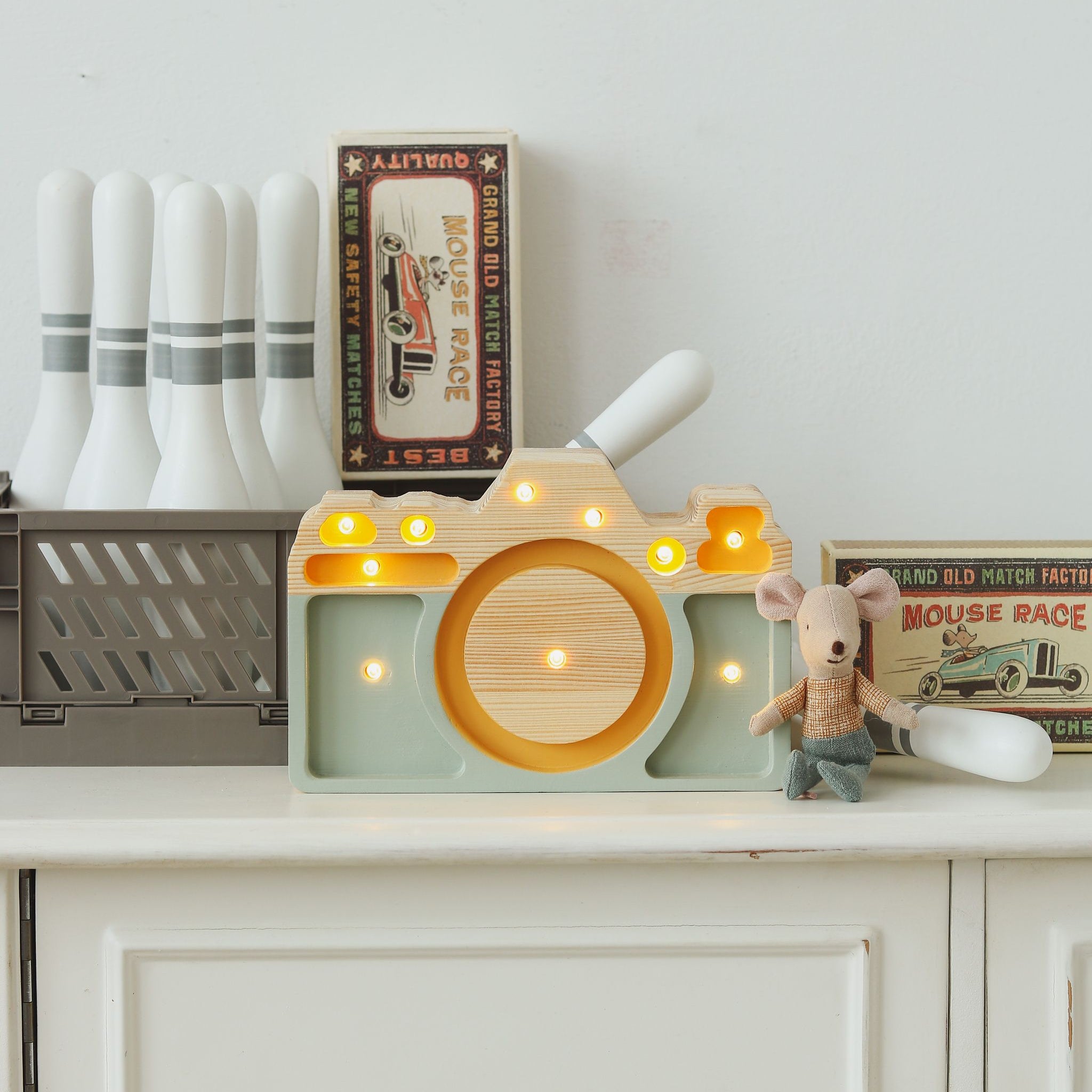 Little Lights Mini Camera Lamp on a dresser in a baby nursery