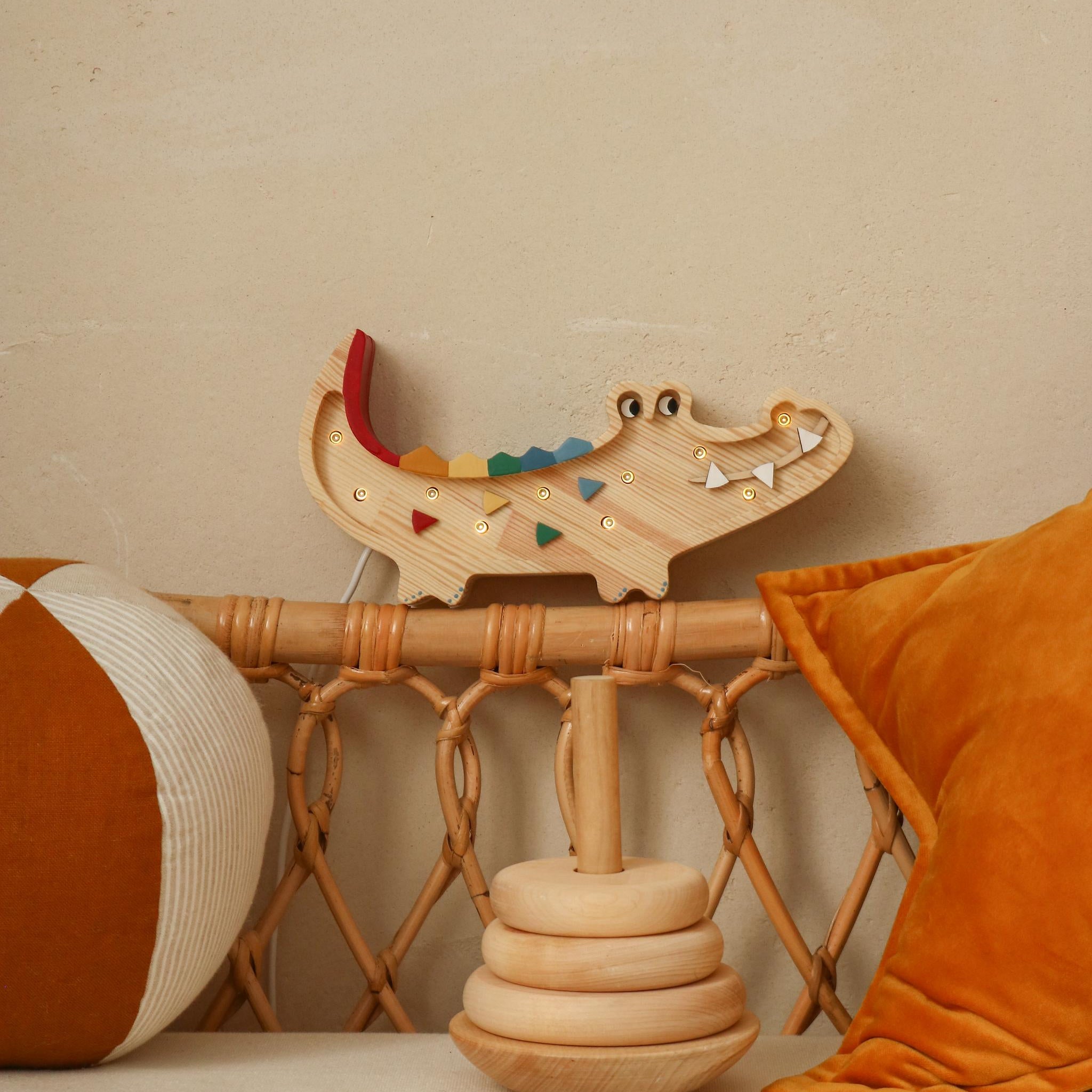 Little Lights wooden Mini Cricidile night light glowing  by the bed in a kids room