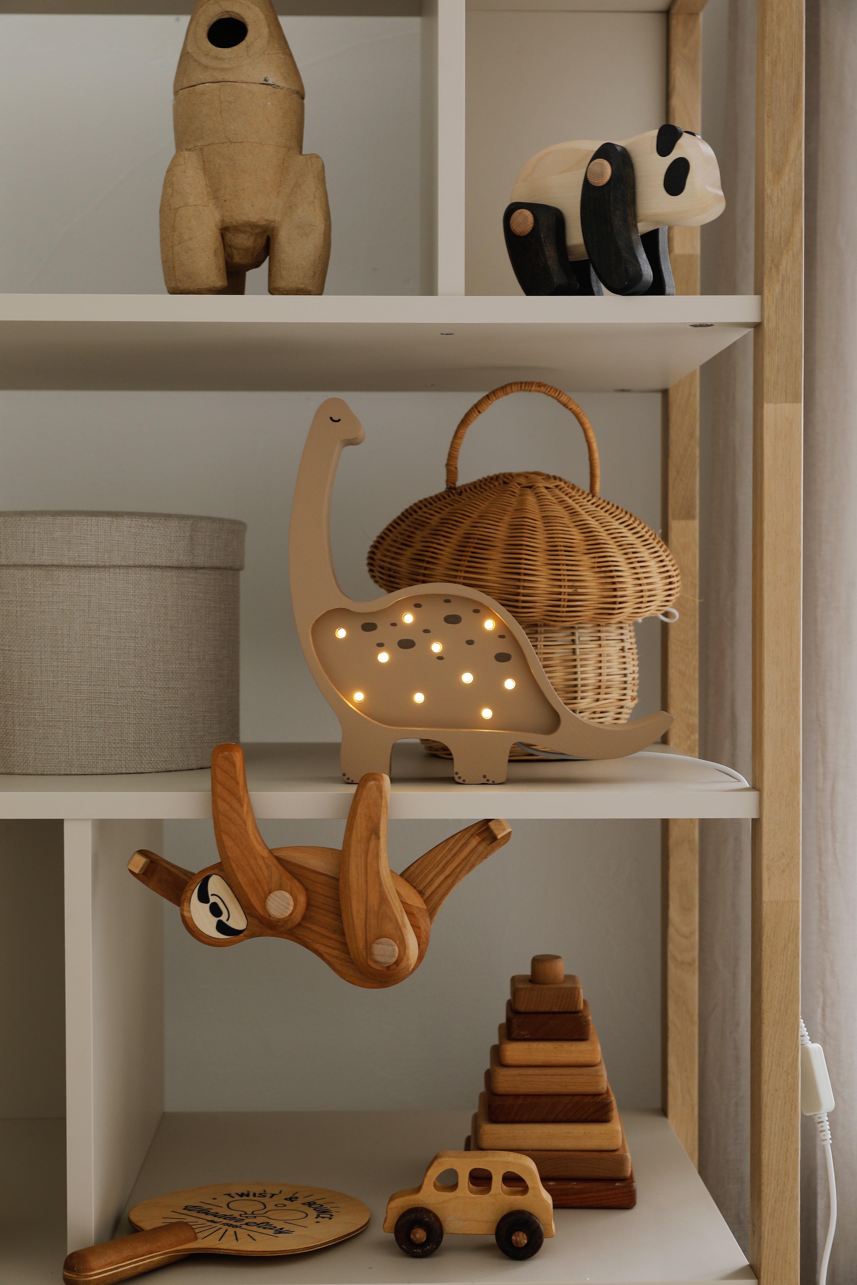 Wooden dino night light in warm coffee tone for kids’ bedrooms
