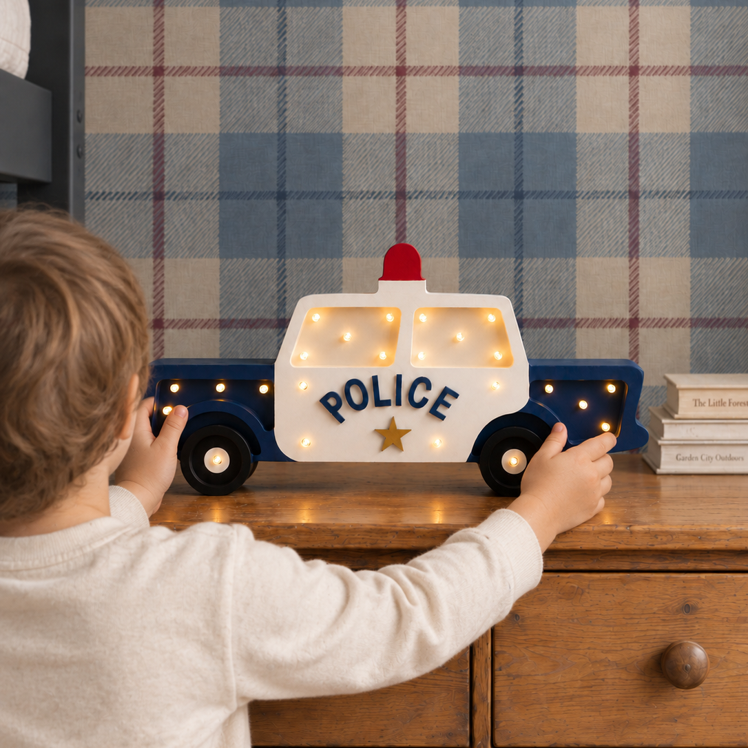 A boy in his room standing by his police Car Night Light