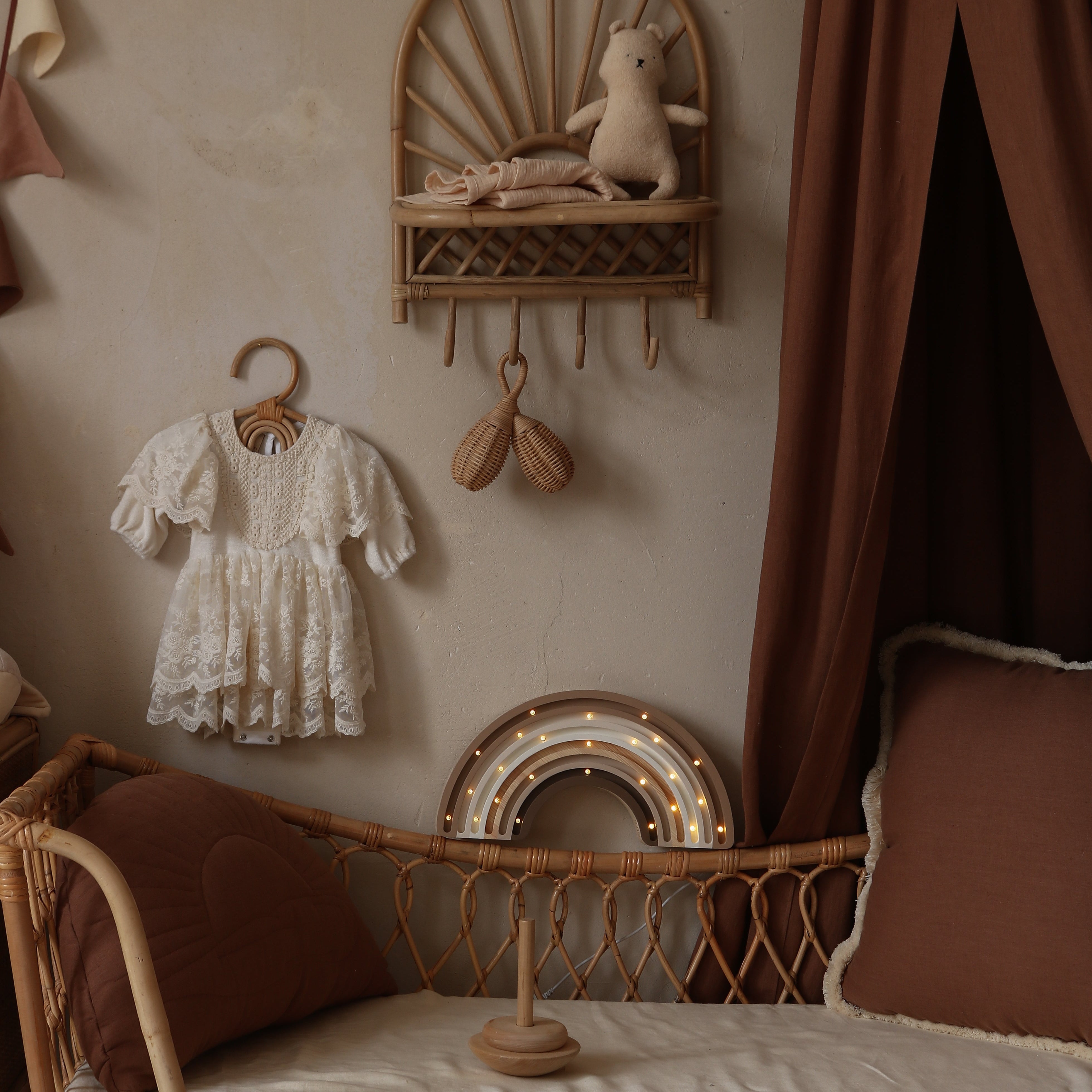 Rainbow Lamp in a nursery room with wicker crib,and decorative items on the wall.