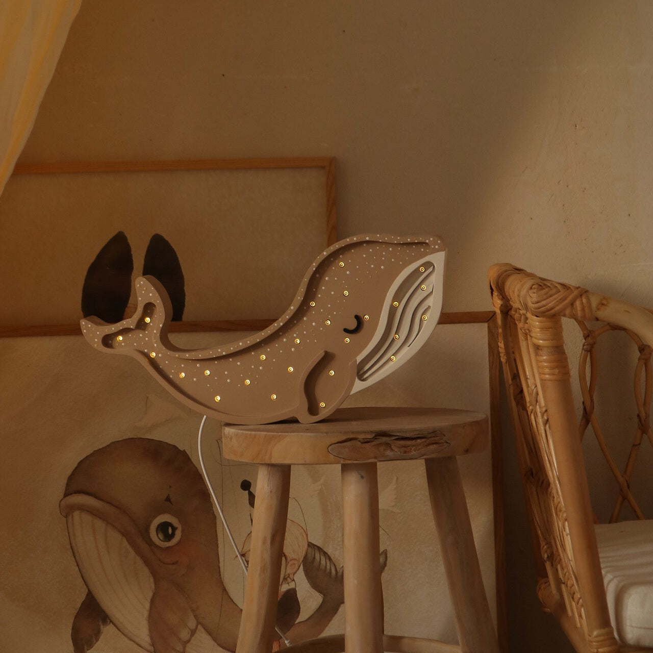 Brown Whale lamp on a wooden stool in a kid's room