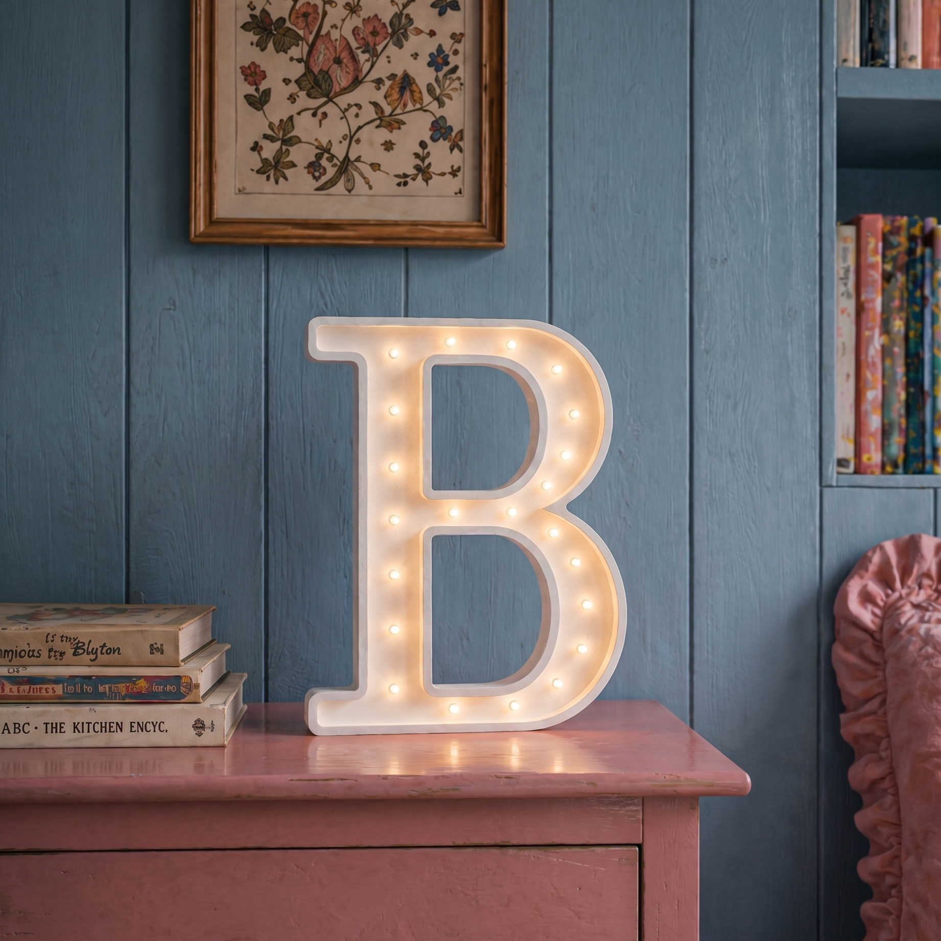 Little Lights white B Letter night light glowing on a dresser in a girl's room