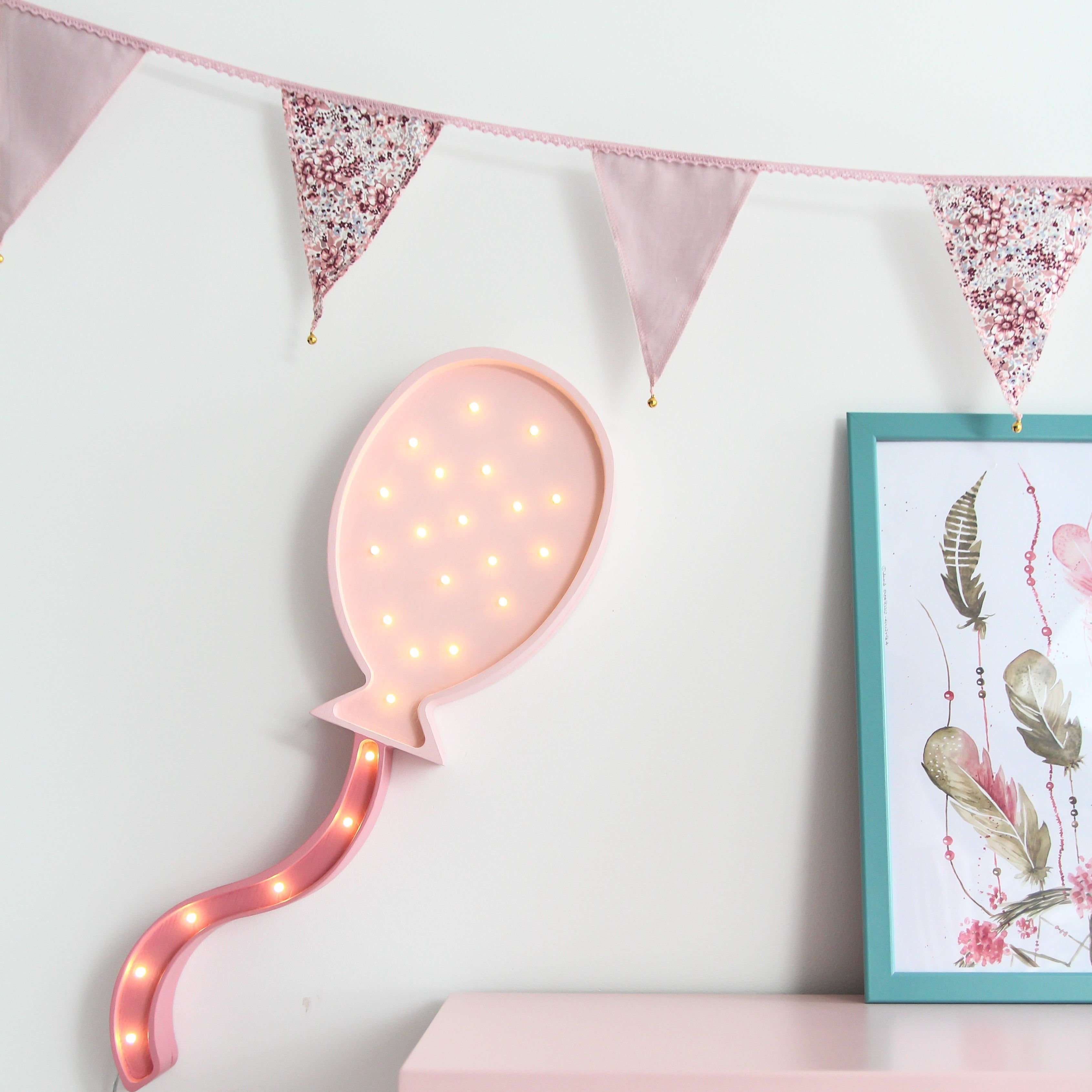 Little Lights Balloon Lamp hanging on the wall in a girl's room